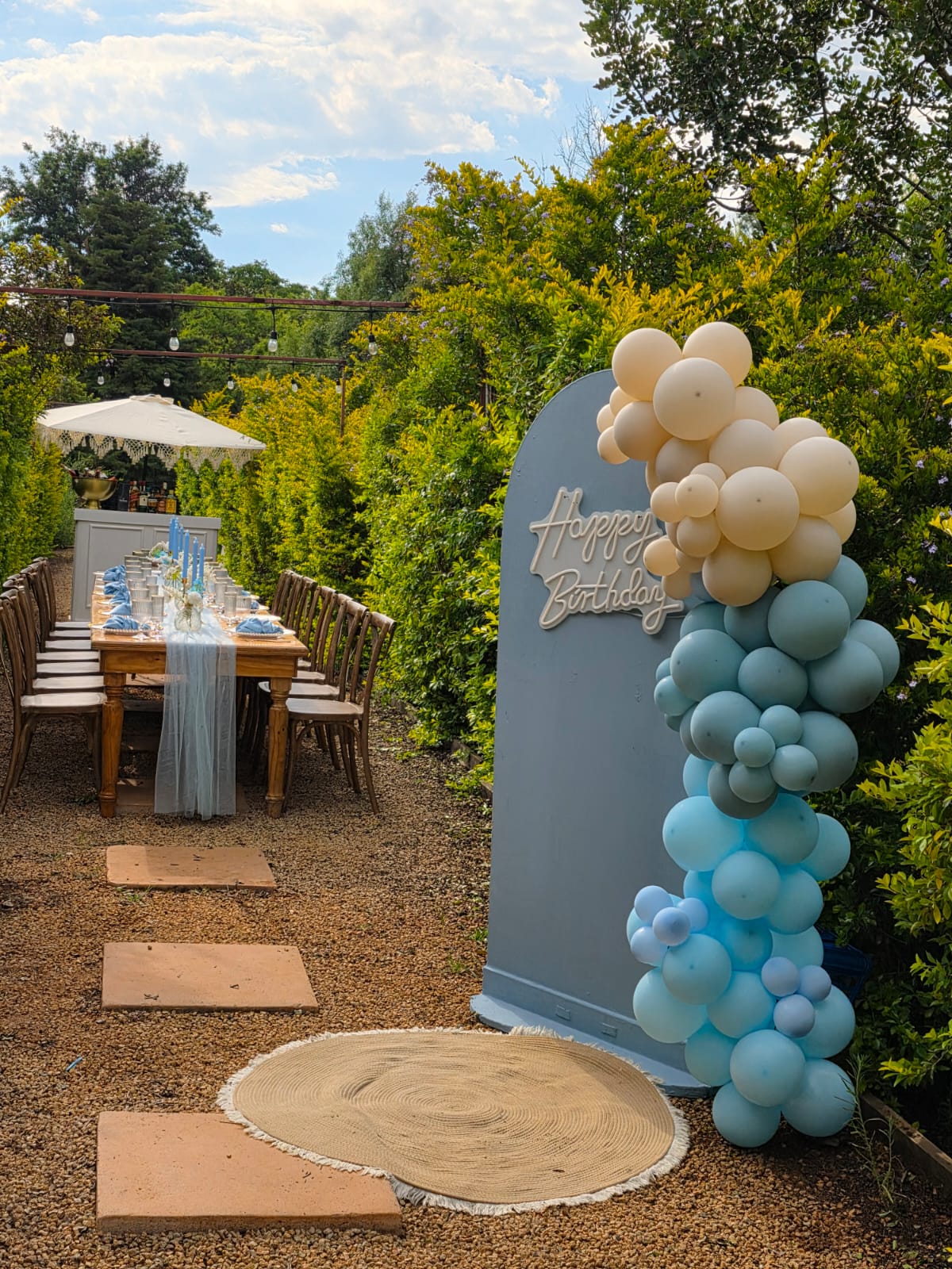 Birthday celebration setup in Muano Functions Venue garden with balloon arch and styled dining table