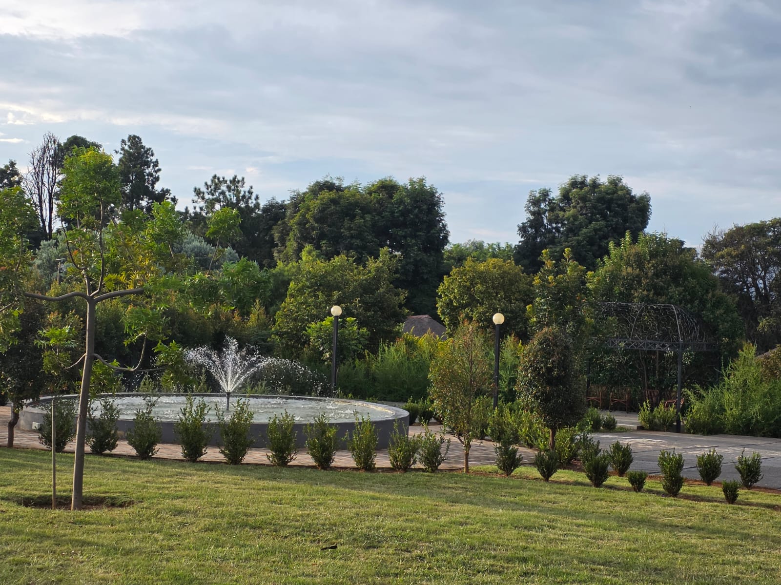 Tshedza Gardens fountain and wrought-iron gazebo surrounded by manicured lawns and trees